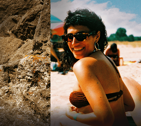 Steine und eine junge Frau in Bikini und Sonnenbrille am Strand