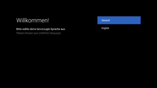 Magenta TV Box - Sprachauswahl Bildschirm zur Sprachauswahl auf der Magenta TV Box. Zur Auswahl stehen Deutsch und Englisch, Deutsch ist markiert. Der Nutzer wird gebeten, die bevorzugte Sprache auszuwählen.