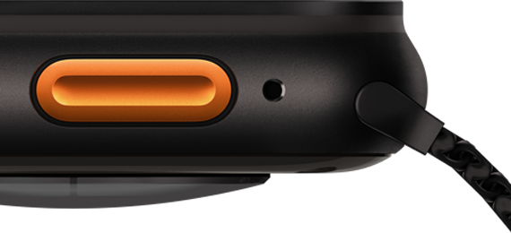 Apple Watch Ultra 3 Actionbutton Apple Watch Ultra 3, Farbe Schwarz, Titangehäuse, konvexer Sensor auf der Rückseite, linke Seitenansicht, Lautsprecher/Lüftungsöffnung, Actiontaste, Mikrofon